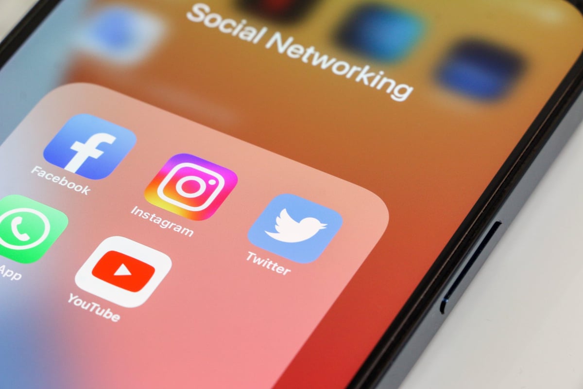 Social media app icons on smartphone representing digital marketing and social strategy
