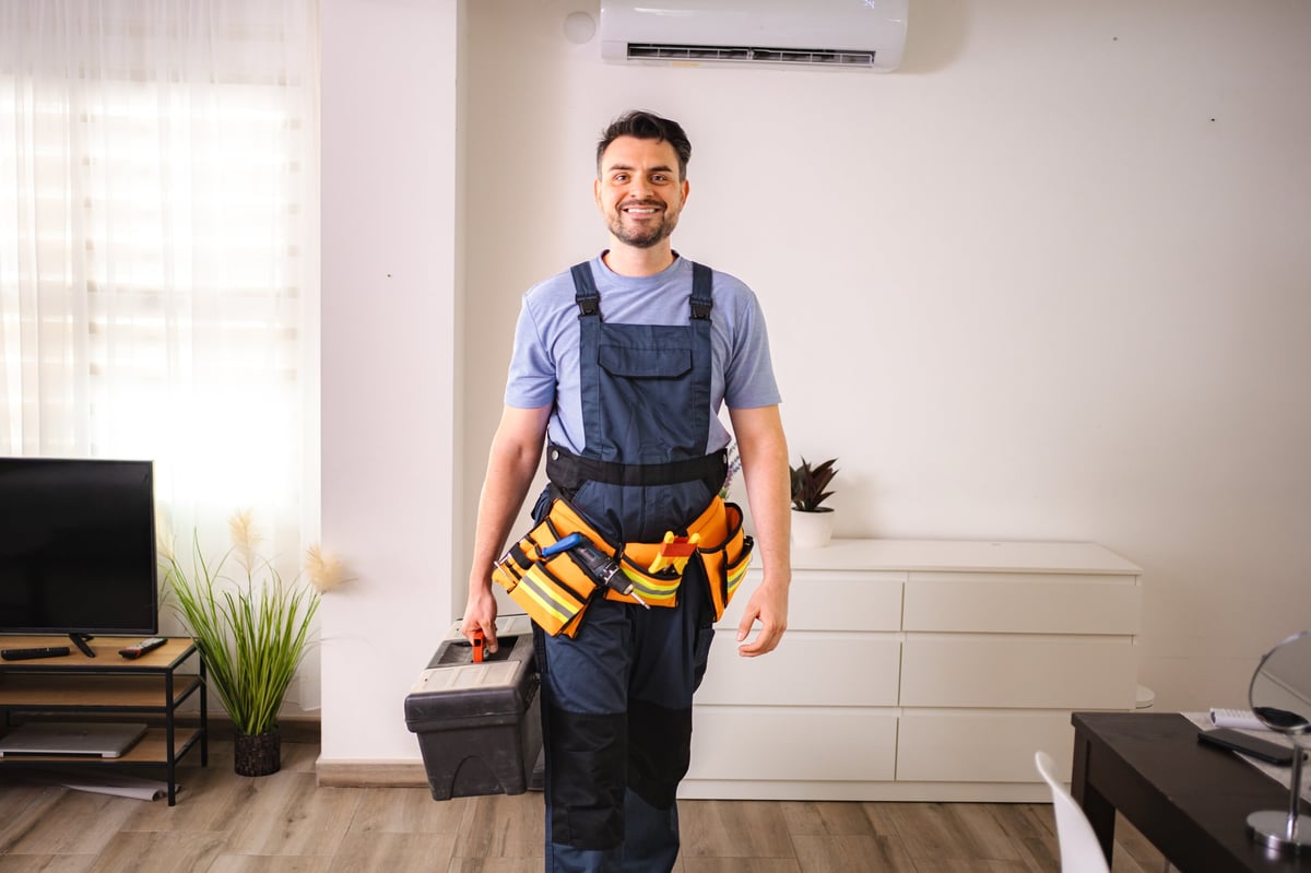 Professional technician with toolbox serving residential homes