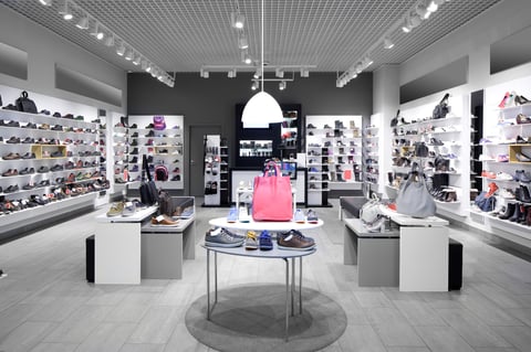 Bright and fashionable interior of shoe store in modern mall